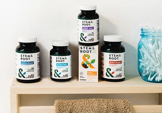 Boxes of Stem & Root on a bathroom cabinet shelf