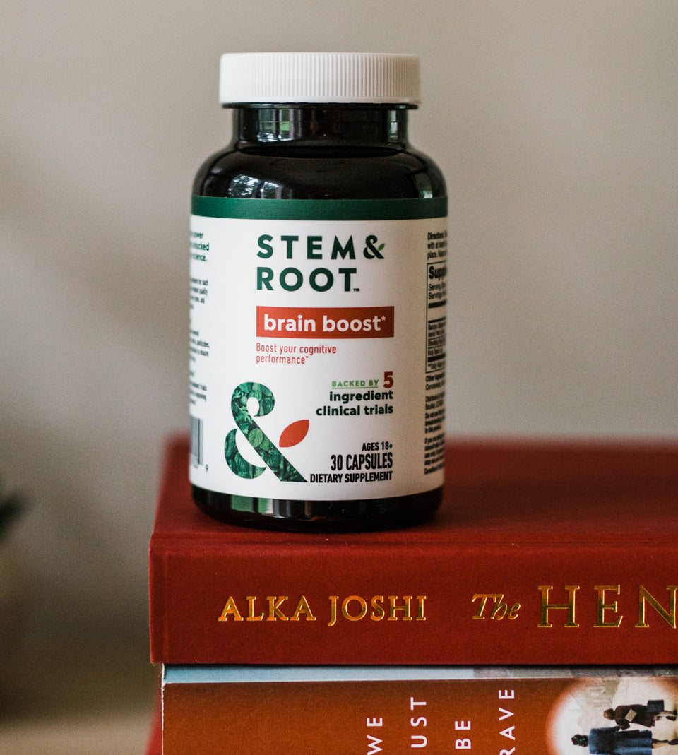 Bottle of Brain Boost on top of a stack of books