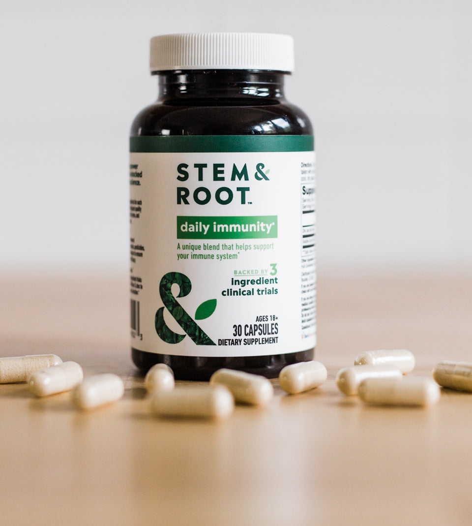 Bottle of Daily Immunity on a table with capsules
